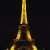 Eiffel Tower at night lit up in yellow lights