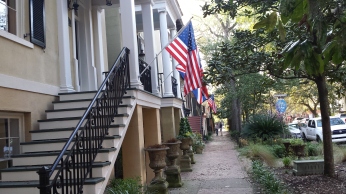 historic houses with USA flag hanging outside