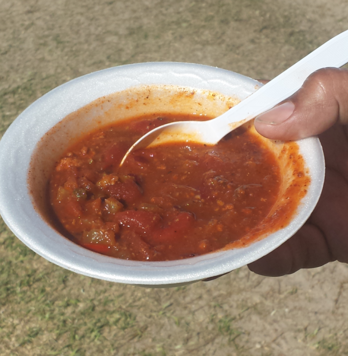 a bowl of chili with a spoon in it